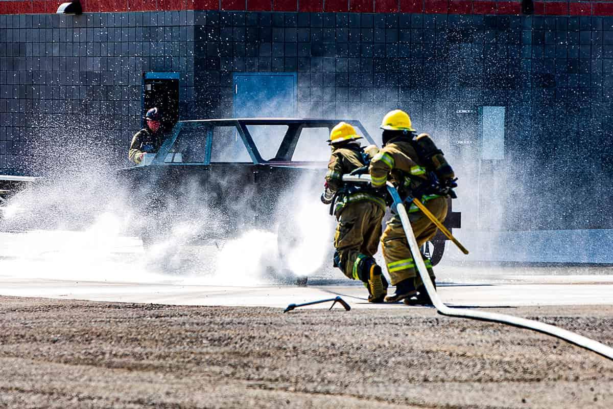 Students in the Fire Science Program putting out a fire